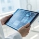 monitoring sepsis treatment via Machine Learning, Intensive Care Doctor analyzing data on a tablet
