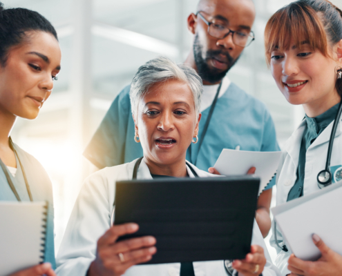 Physicians and nurse in hospital looking at tablet for results. Healthcare, teamwork and virtual critical care tech for physician outsourcing support