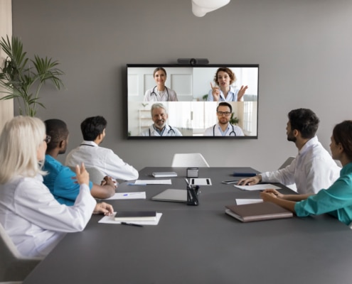Virtual introduction of telehealth intenstivists to department team gathered in hospital conference room